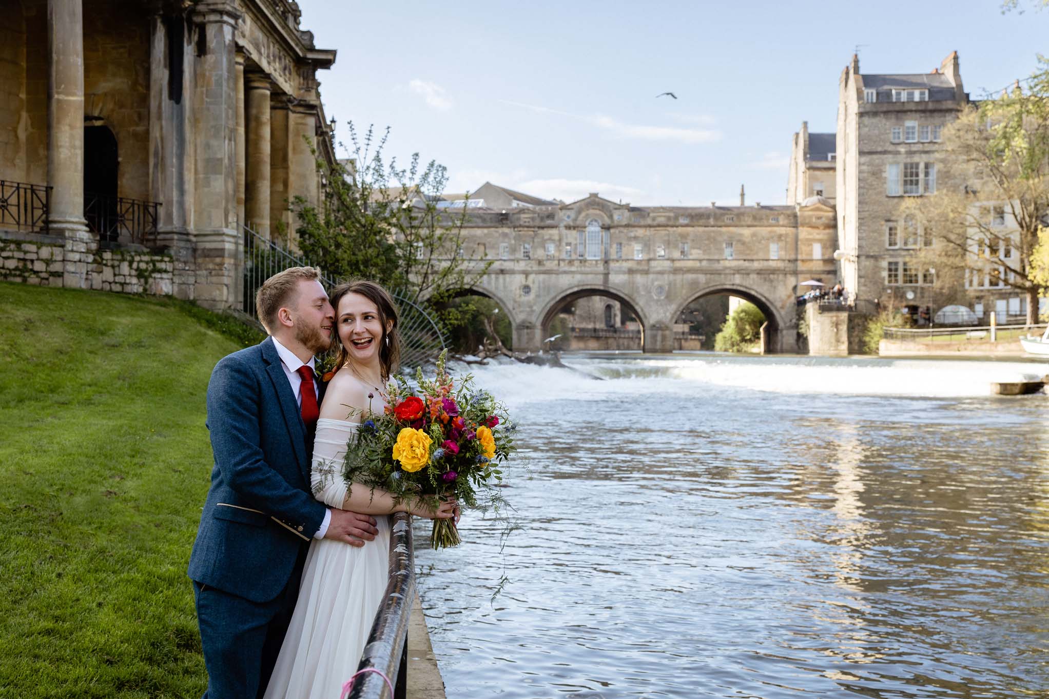 Wedding couple with view of Pulteney Bridge from Parade Gardens