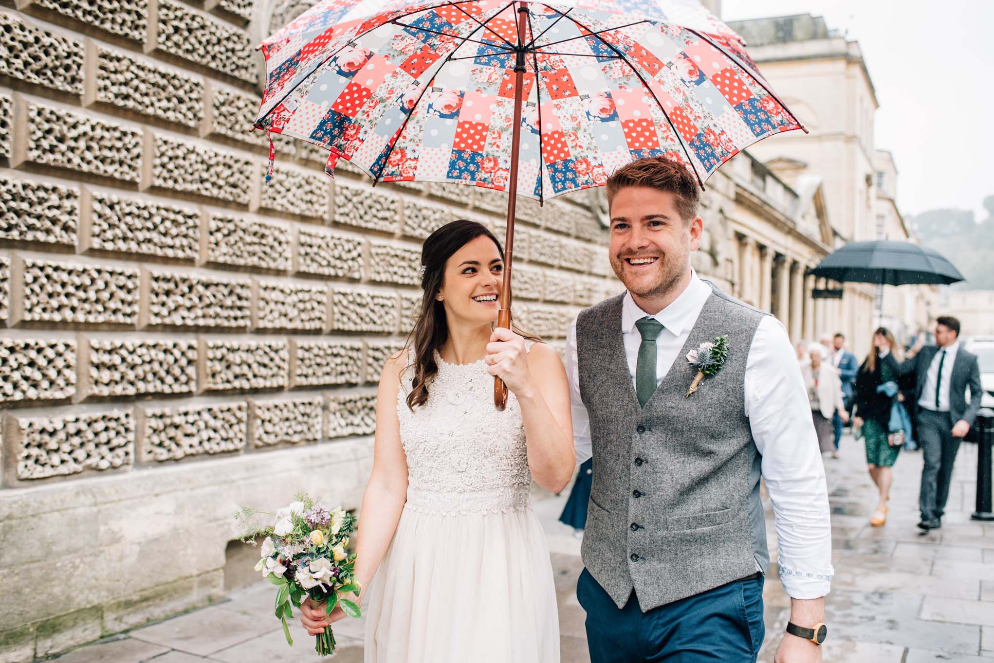 Wedding couple in Stall Street with an umbrella