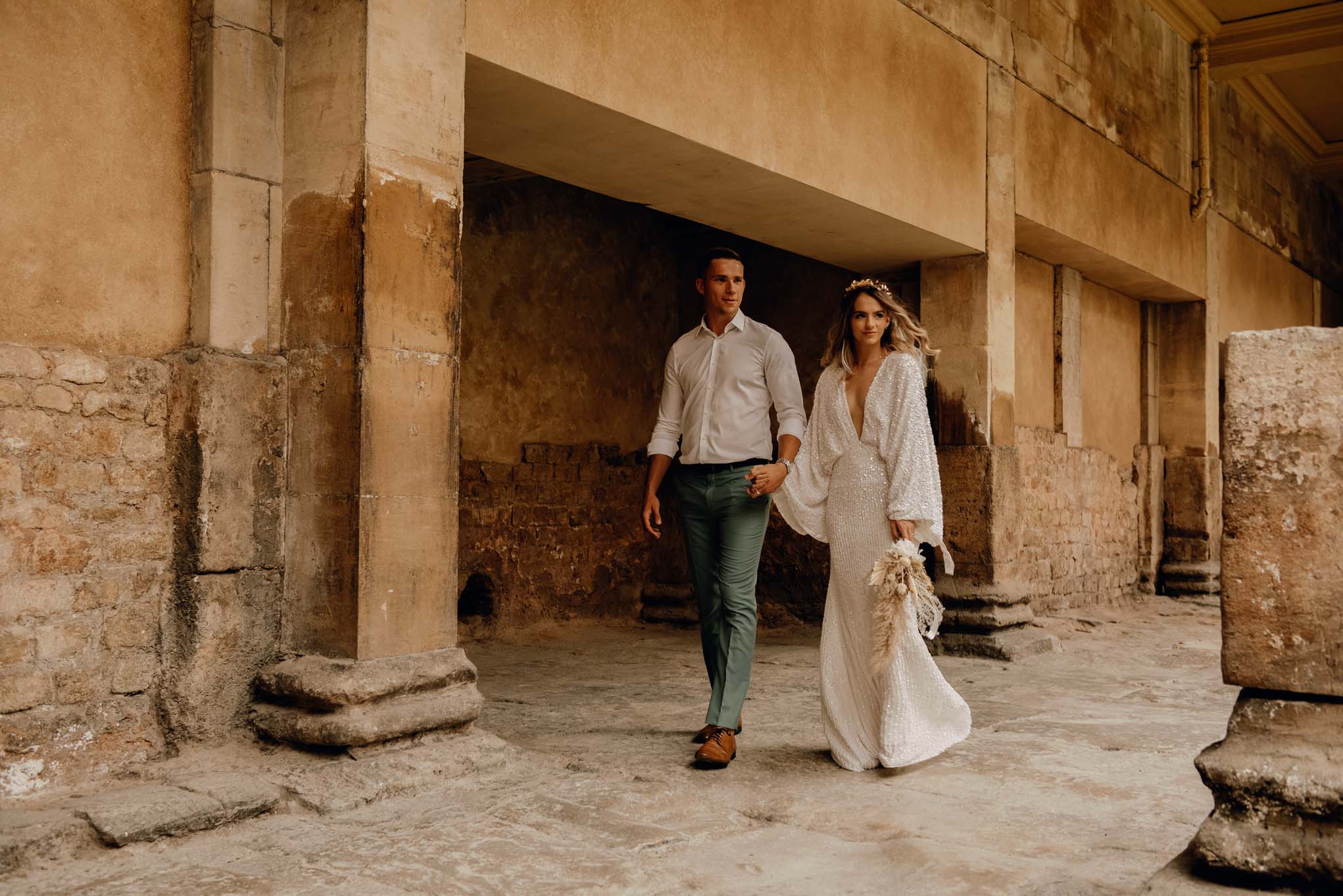 Wedding couple walking by the Great Bath