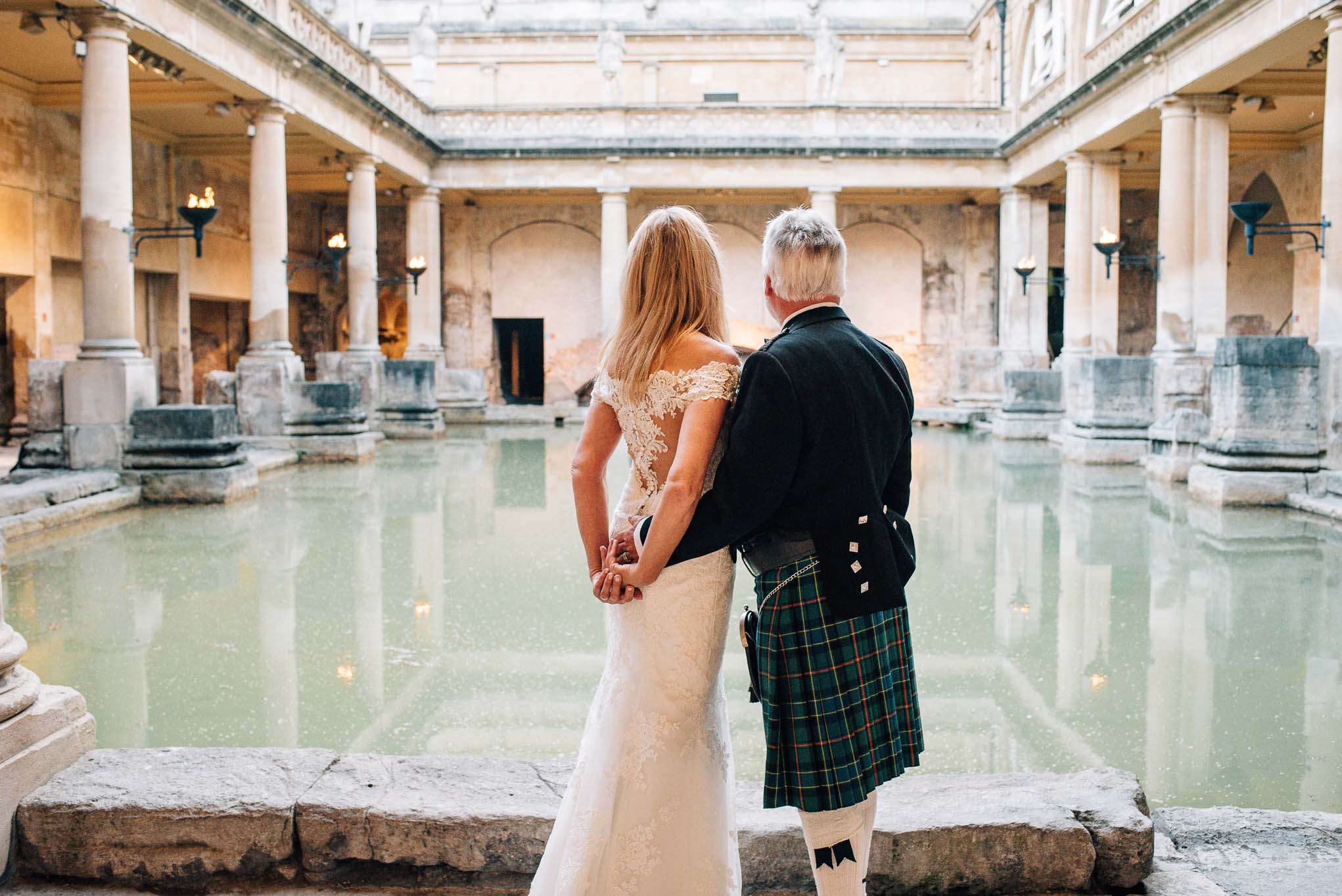 Newly married couple look out over the Great Bath