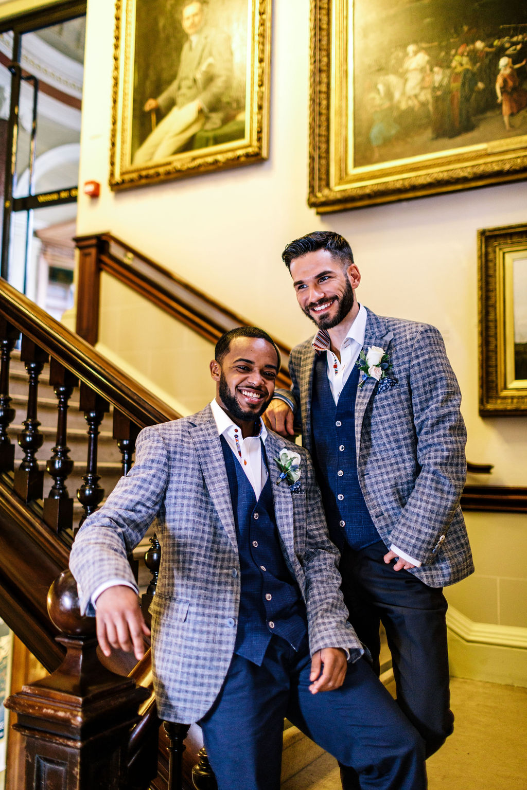 Wedding couple stand on stairs at Victoria Art Gallery