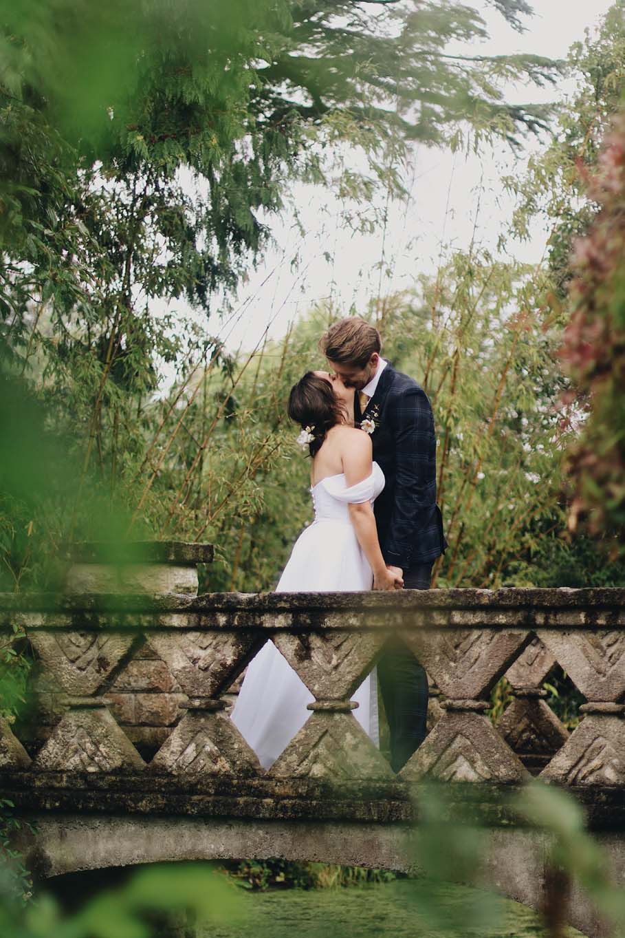 Wedding couple pose on ornamental bridge, Botanical Gardens
