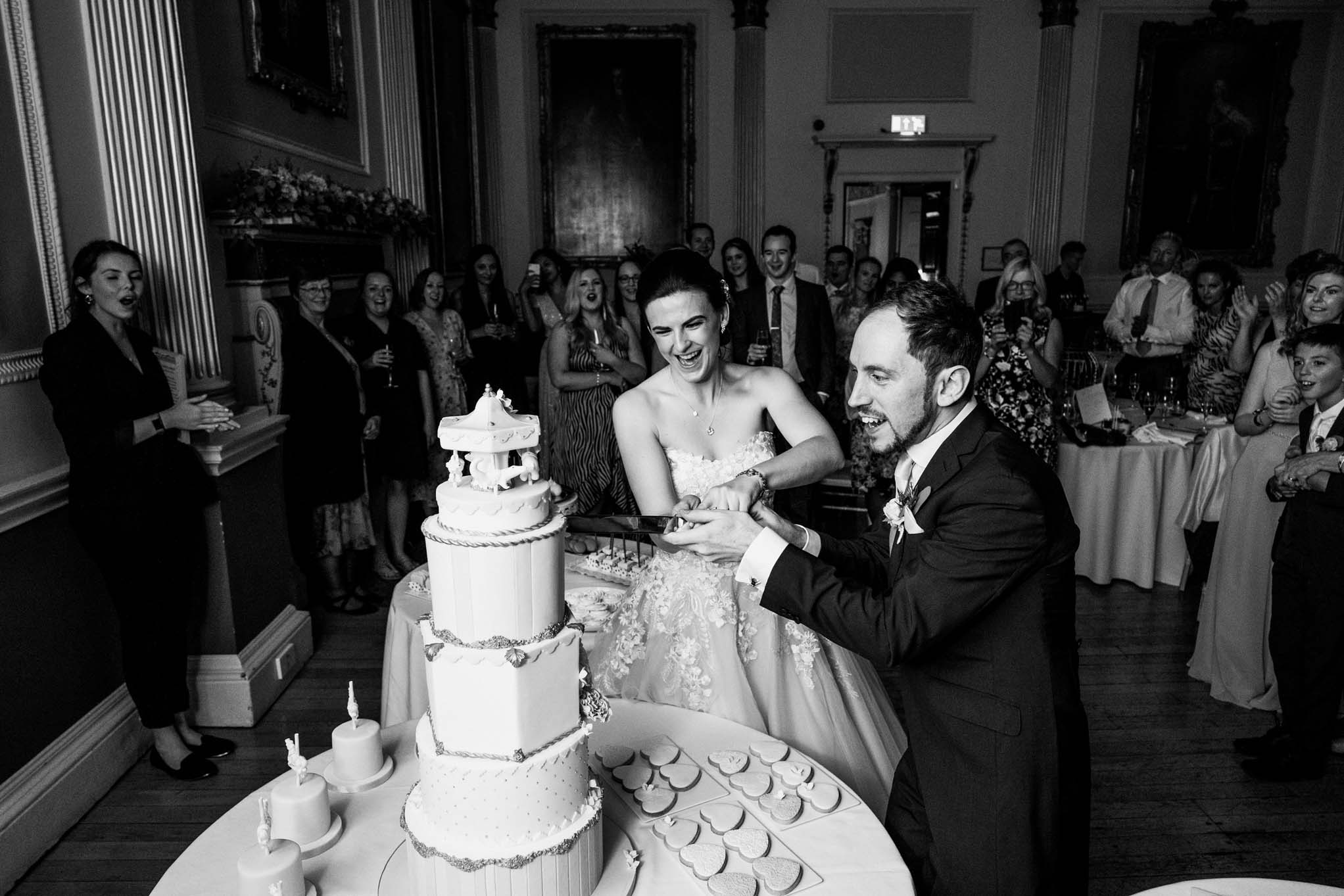 Wedding couple cutting their cake in the Banqueting Room
