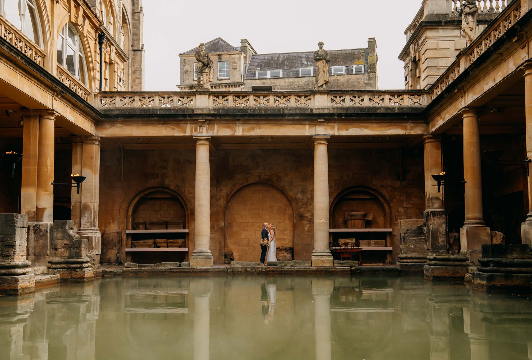 Wedding couple viewed across the Great Bath