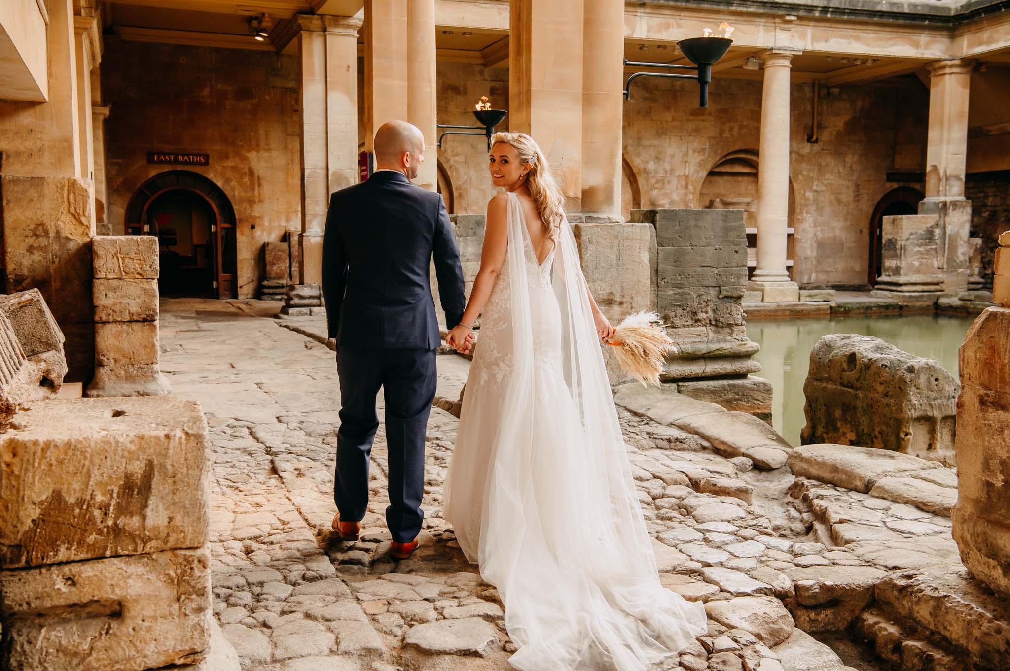 Wedding couple leave the Roman Baths