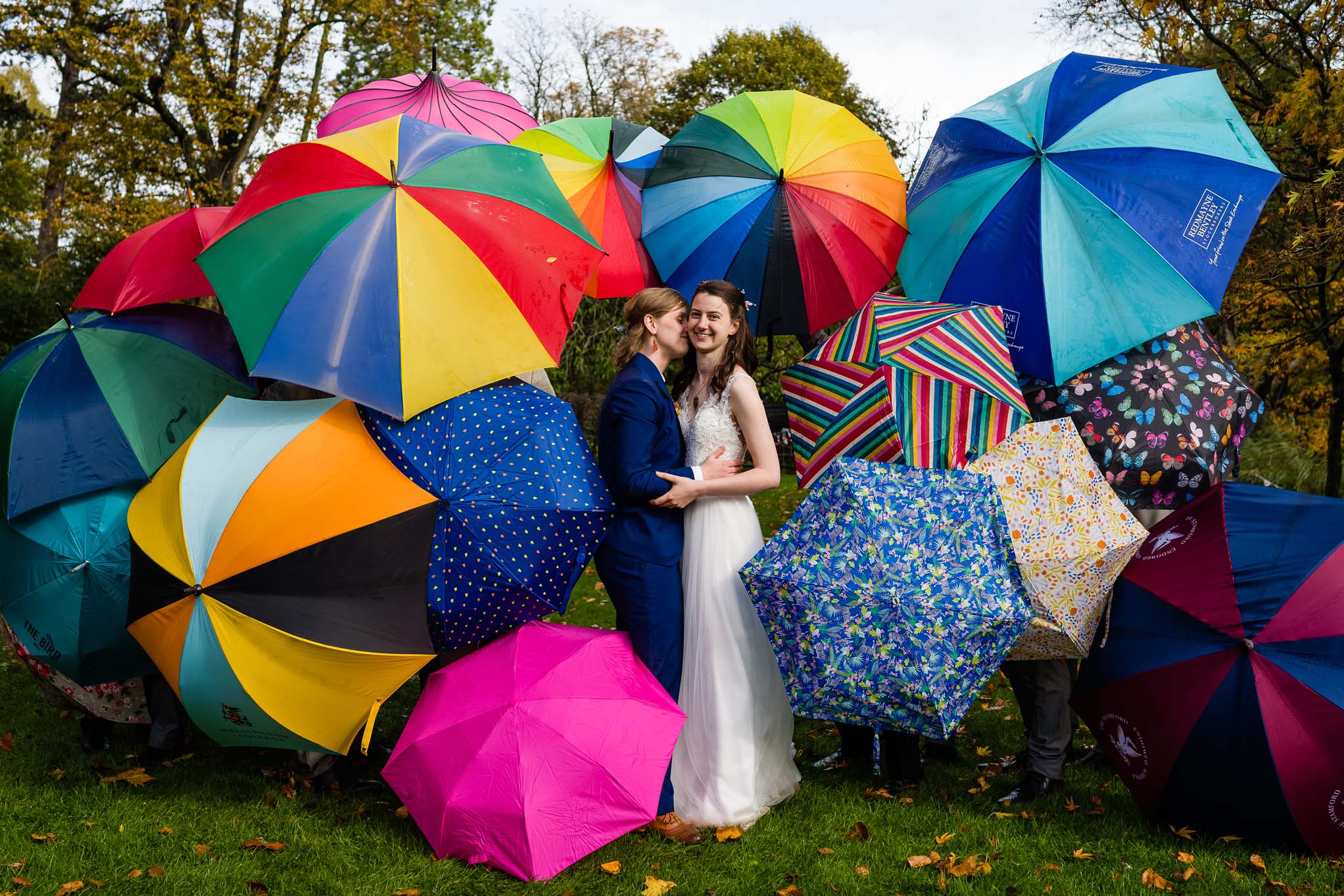 Wedding couple surrounded by colourful umbrellas