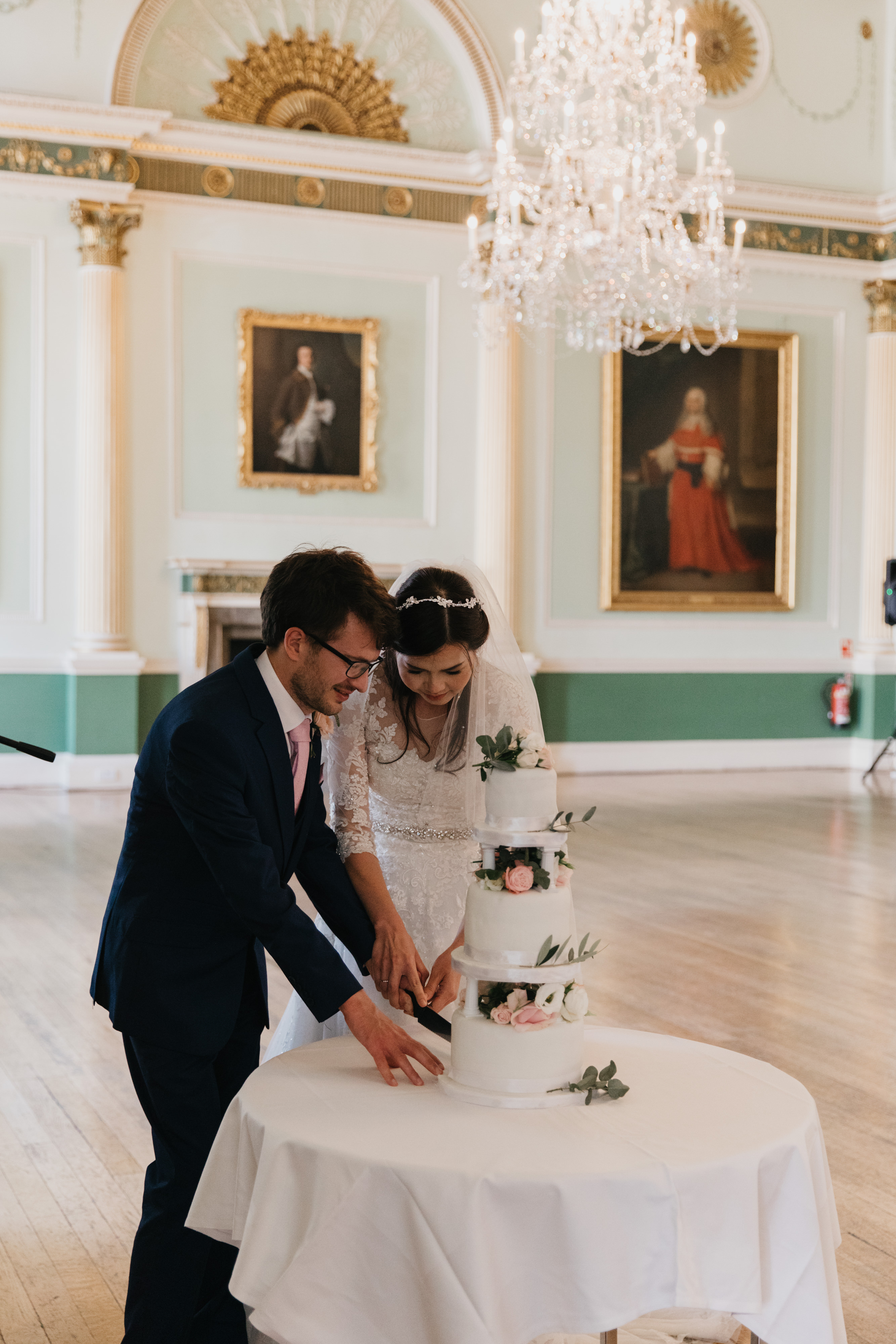 Wedding couple cut their cake in the Banqueting Room