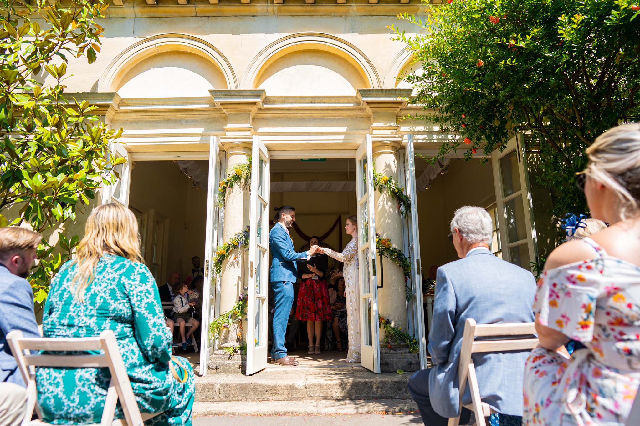 View of wedding ceremony from outside the Temple of Minerva