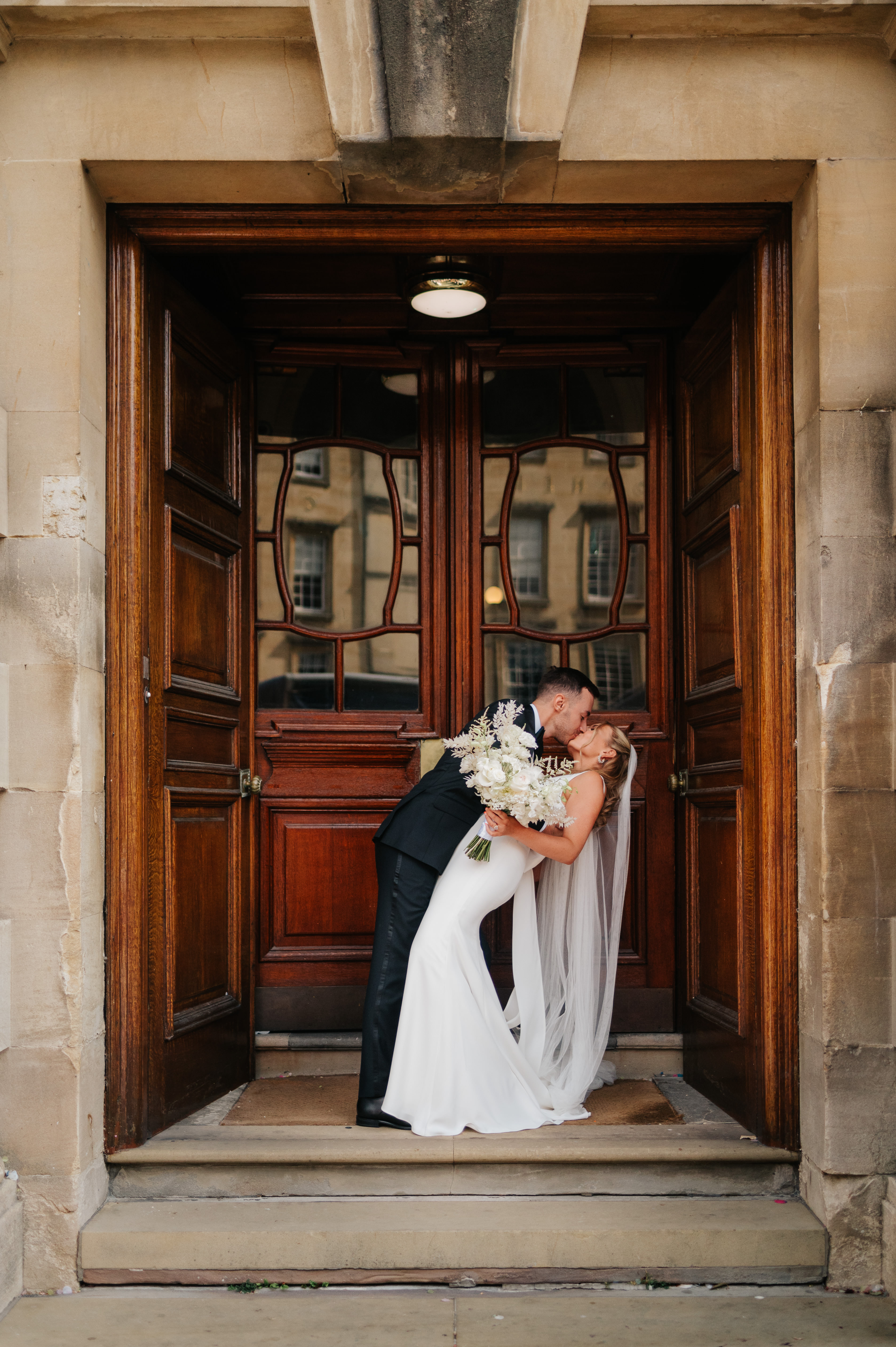 Wedding couple embrace on the Guildhall steps