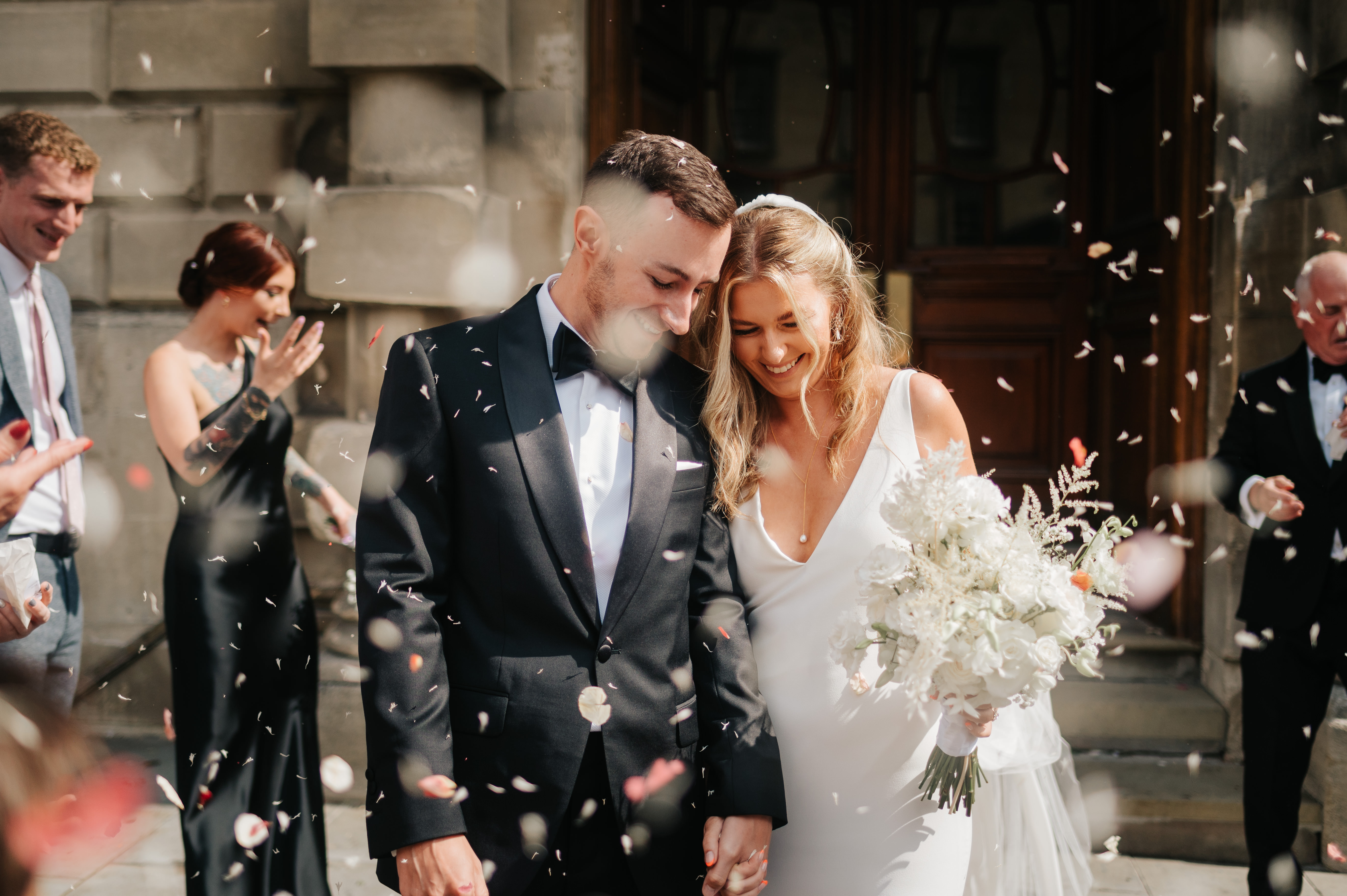 Wedding couple with confetti floating around them