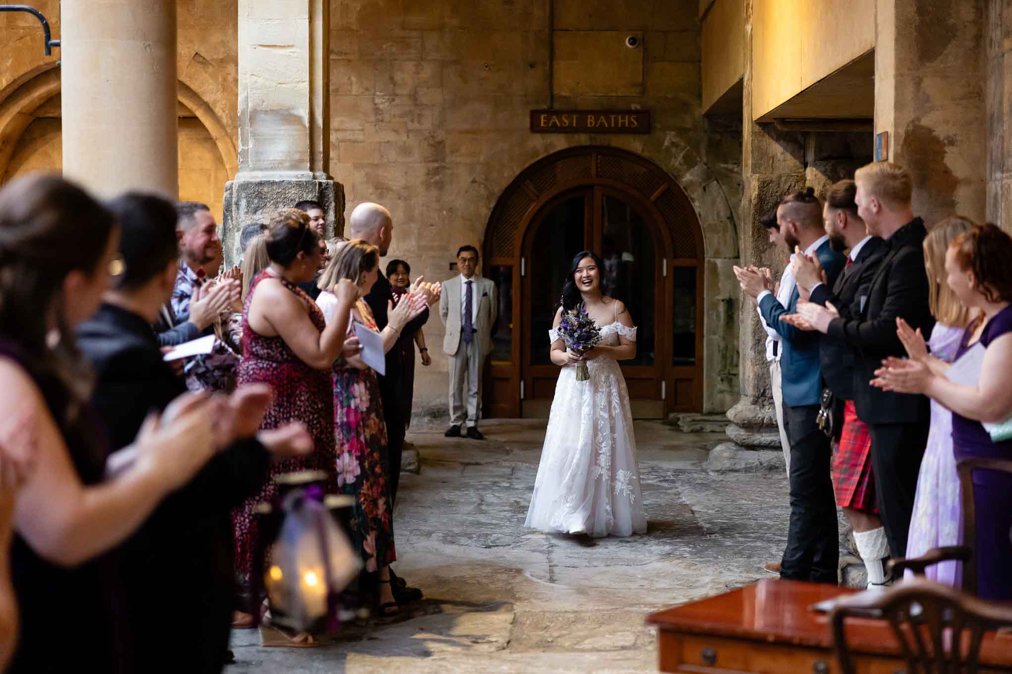 Bride arrives for ceremony beside the Great Bath