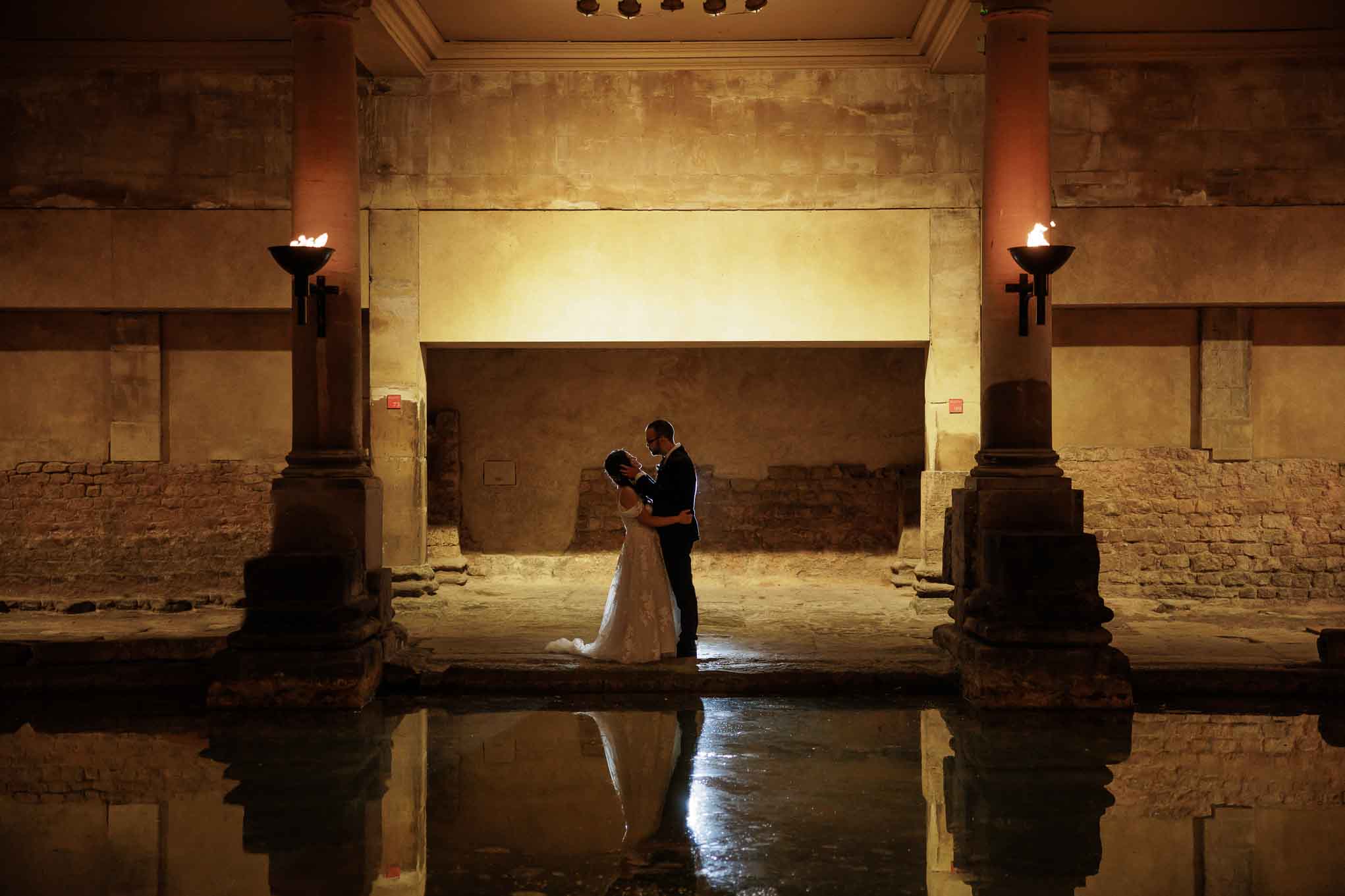 A couple embrace beside the Great Bath