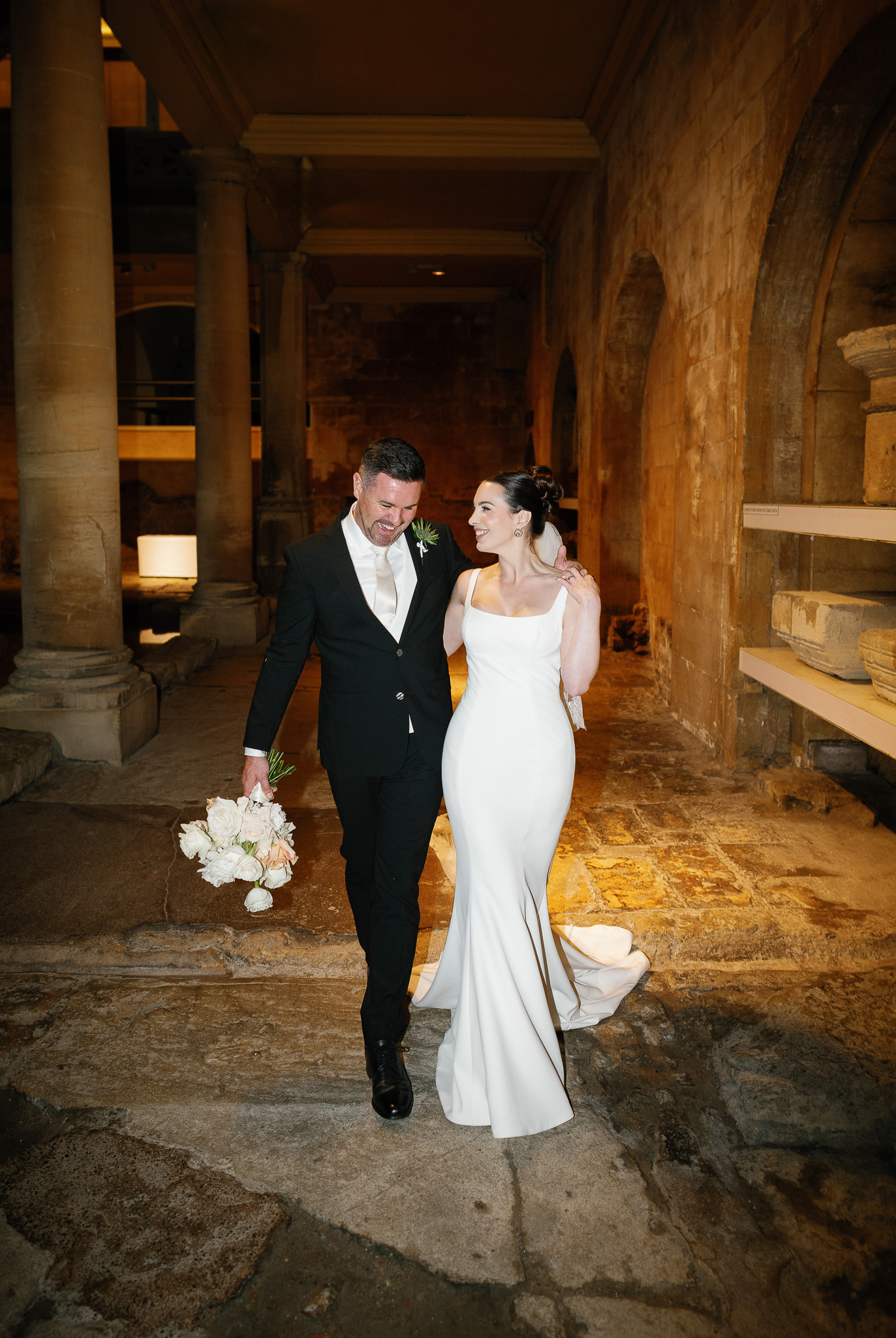 Couple walk beside the Great Bath