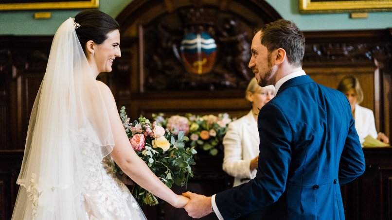 Couple exchanging vows in front of registrar